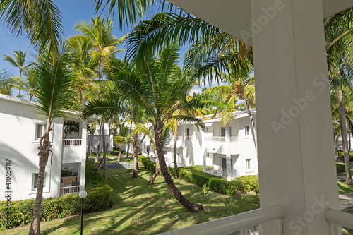 White villas exterior in tropical garden at sunny day photo