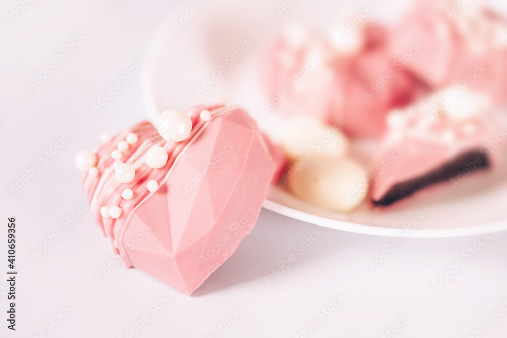 Pink heart-shaped cake on a plate. Gift for Valentine's Day and Women's Day Pink heart-shaped cake on a plate. Gift for Valentine's Day and Women's Day