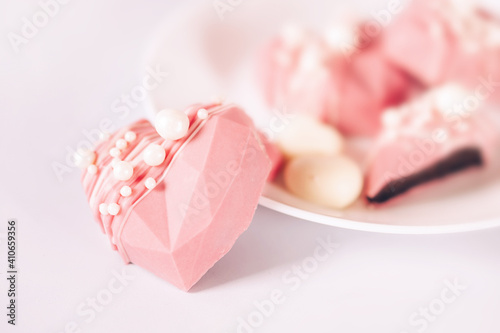 Pink heart-shaped cake on a plate. Gift for Valentine's Day and Women's Day