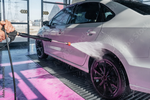 car wash with a spray of pink foam from a pistol