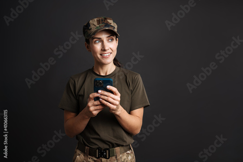 Happy beautiful soldier woman smiling and using mobile phone © Drobot Dean