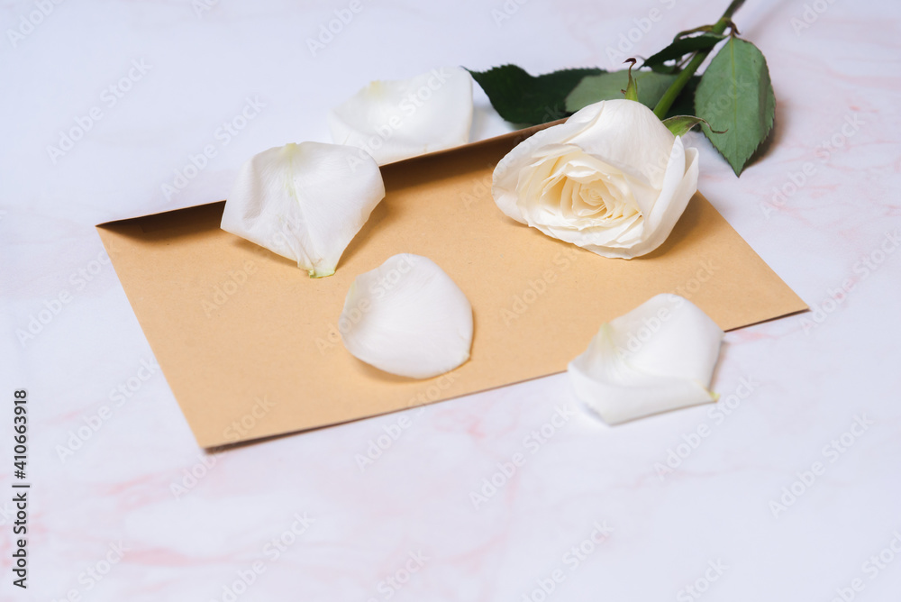 the rose lies on a paper envelope as a background. valentine's day celebration and eighth march concept the rose lies on a paper envelope as a background. valentine's day celebration and eighth march concept