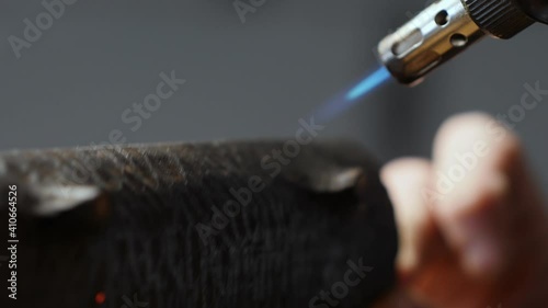 a carpenter burns a wooden tea stand with a burner. the art of woodworking. handmade concept