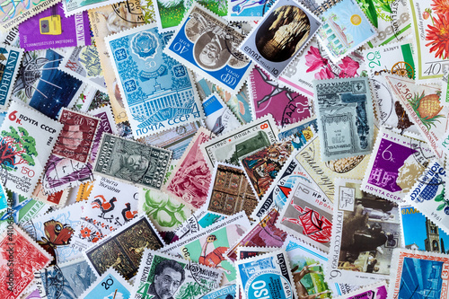 Background from old multicolored postage stamps collection from different countries