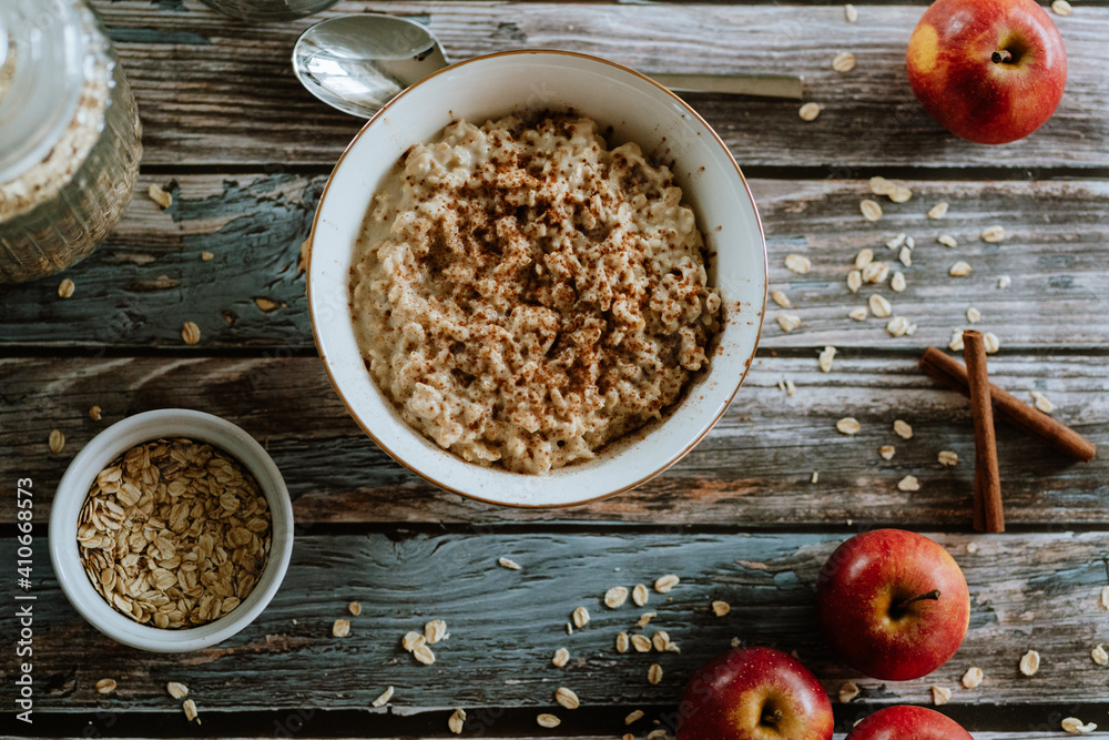 A porridge bowl with apples and cinnamon, food still life, healthy breakfast