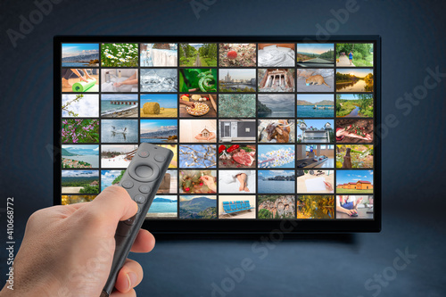 Person holds remote control. TV multimedia panel. Multimedia streaming concept. man holds remote control. VoD content provider concept. Television streaming,