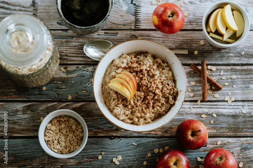 A porridge bowl with apples and cinnamon, food still life, healthy breakfast