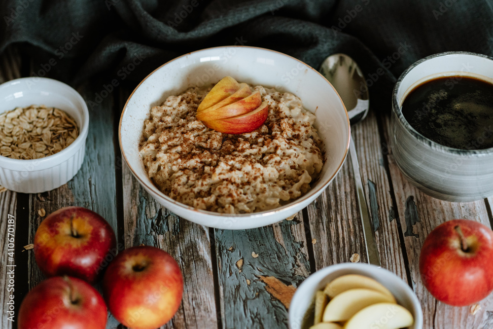 A porridge bowl with apples and cinnamon, food still life, healthy breakfast
