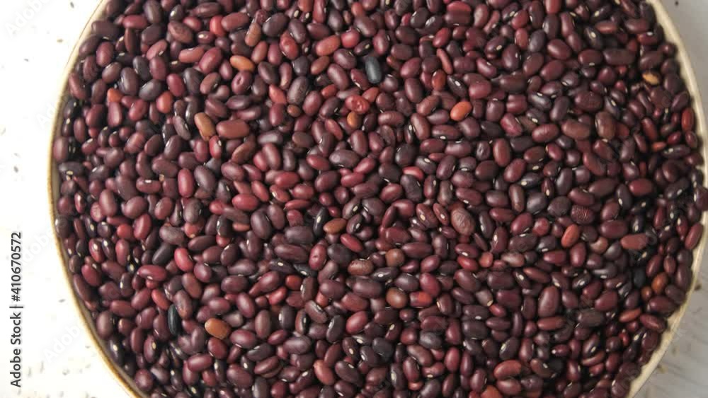 Close-up of red beans scattered on the table. High-protein legumes, beans and lentils for a healthy diet. Rotation Close-up of red beans scattered on the table. High-protein legumes, beans and lentils for a healthy diet. Rotation