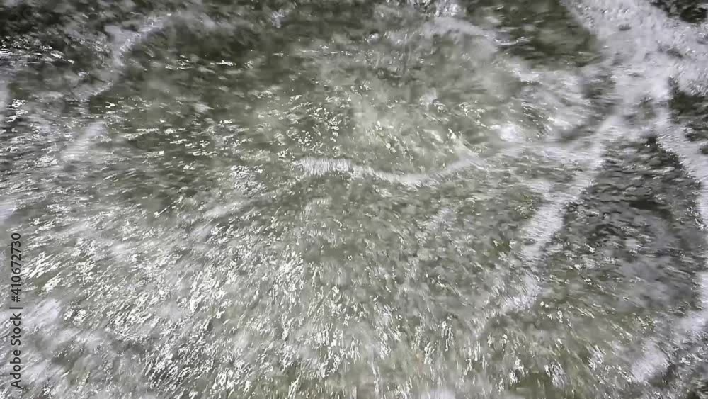 Air bubbles coming out of the water creating movement and foam in a tank of a purification plant Air bubbles coming out of the water creating movement and foam in a tank of a purification plant