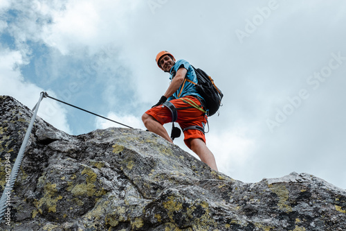 Alpinista in azione su via ferrata photo
