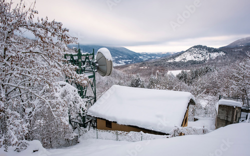 Snowy panorama of the hills surrounding the village of Brallo (Lombardy, Northern Italy, Pavia Province), village in the hilly area of Oltrepo Pavese, along the road pass between Lombardy and Liguria. photo