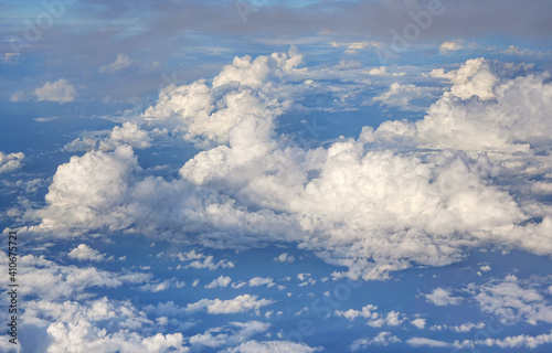 Fluffy sky clouds lit by afternoon sun, as seen from commercial airplane flying over © Lubo Ivanko