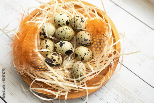 Easter. Quail eggs for Easter. Eggs in the nest. colored feathers.