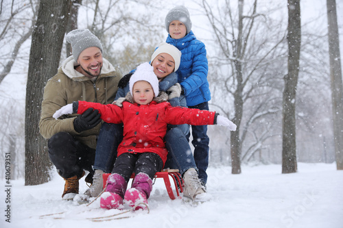 Portrait of happy family outside on winter day. Christmas vacation