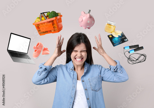 фотографія Overwhelmed woman and different objects around her on light grey background