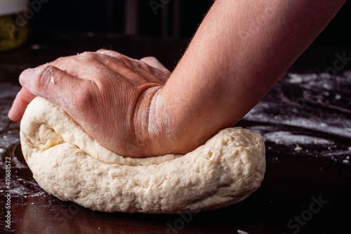 hand of person kneading flour with water and yeast for homemade bread cordoba argentina