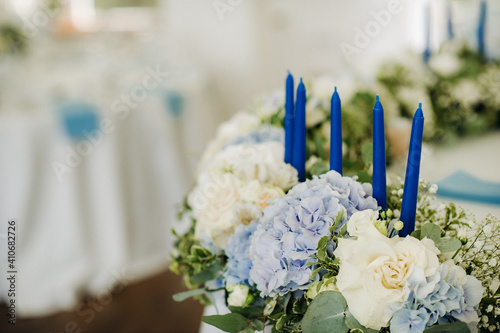 wedding table decoration with blue flowers on the table in the restaurant table decor for dinner at the wedding. photo