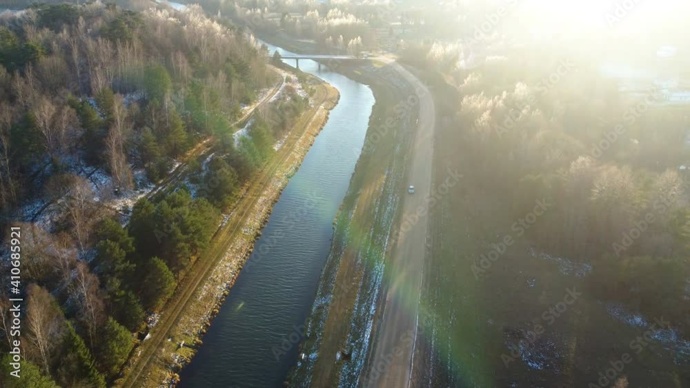 Flying above the water channel in the forest. Drone aerial footage