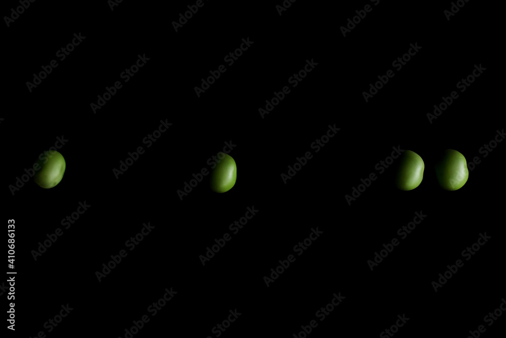 Green peas on the black background | calculator for peas Green peas on the black background | calculator for peas