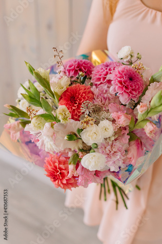 Fototapeta Naklejka Na Ścianę i Meble -  Bouquet of different flowers in women's hands for a gift on Women's Day