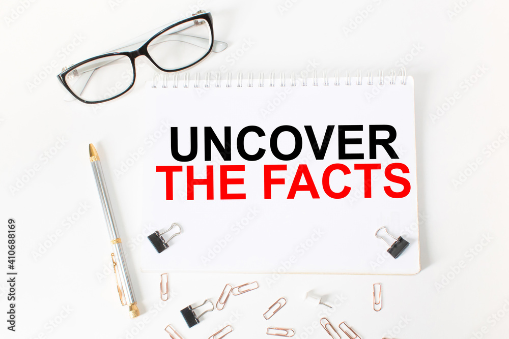 Notepad with inscriptions UNCOVER THE FACTS on a white background. business concept. Notepad with inscriptions UNCOVER THE FACTS on a white background. business concept.