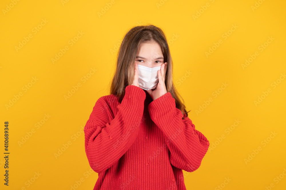 Portrait of young teen girl putting on a protective mask. Portrait of young teen girl putting on a protective mask.