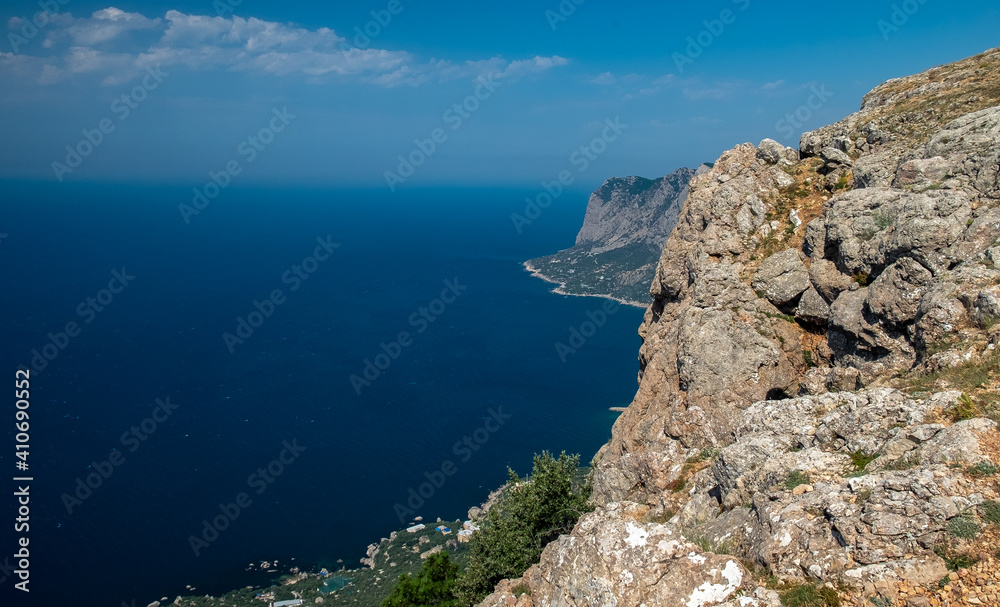 Mediterranean landscape. Forested rocks of the Black Sea coast of the southern coast of the Crimean Peninsula on a clear sunny day. Mediterranean landscape. Forested rocks of the Black Sea coast of the southern coast of the Crimean Peninsula on a clear sunny day.