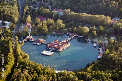 Top view of Lake Heviz, residential buildings and a park with green trees. photo
