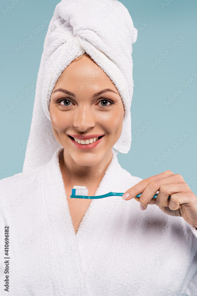 happy woman holding toothbrush with toothpaste isolated on blue happy woman holding toothbrush with toothpaste isolated on blue