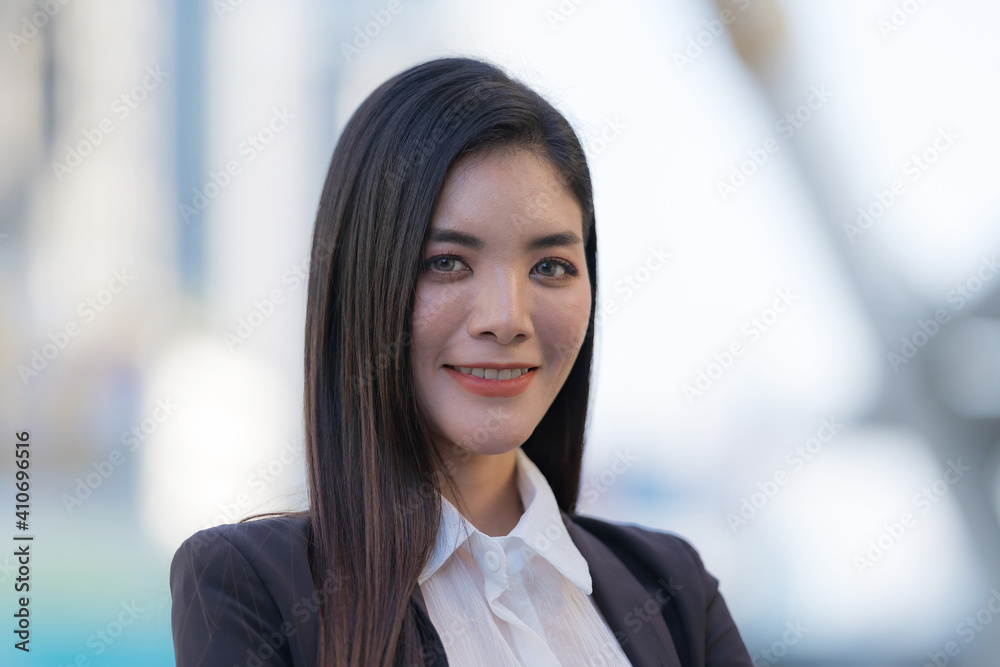 Portrait of smiling business woman while standing in front of modern office Portrait of smiling business woman while standing in front of modern office