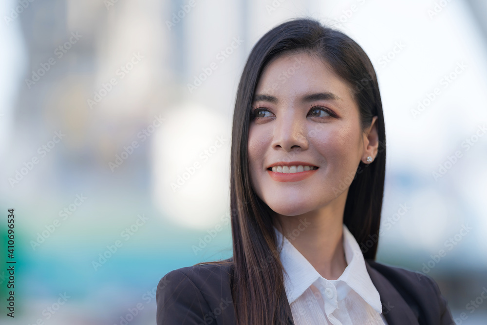 Portrait of smiling business woman while standing in front of modern office Portrait of smiling business woman while standing in front of modern office