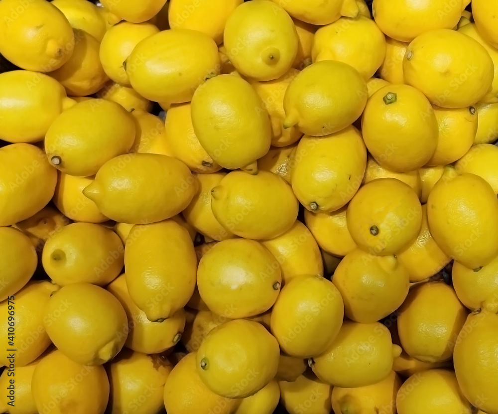 Closeup view  of fresh ripe yellow lemons in the supermarket
