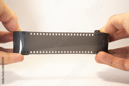old photographic film in hands on white isolated background with copy space