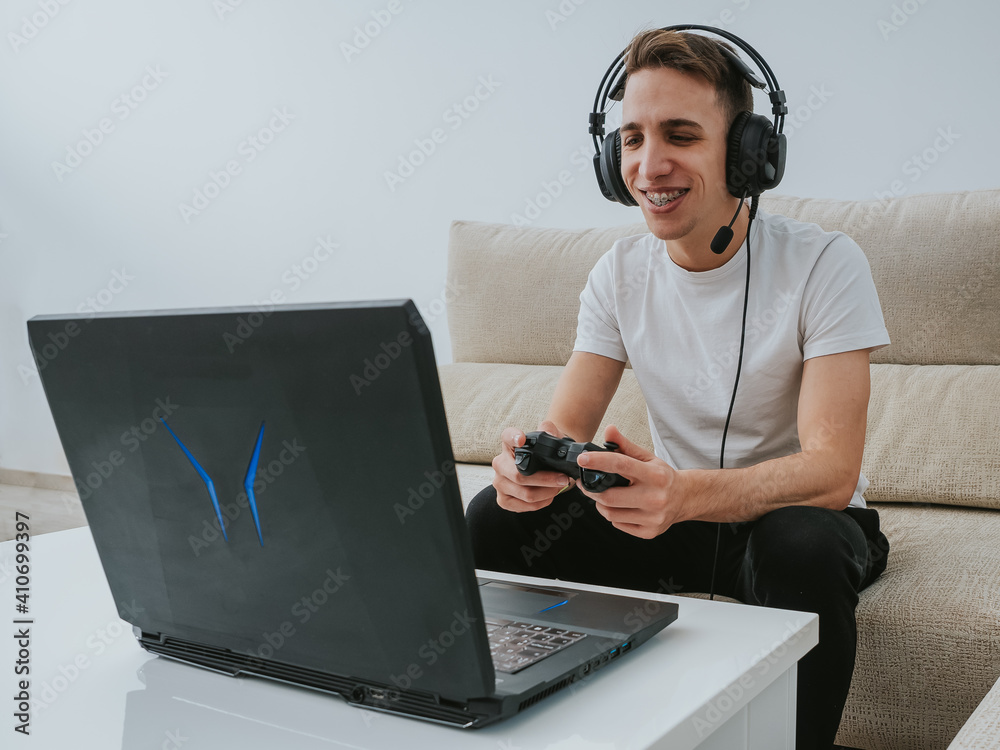 Young gay man playing video games at home Young gay man playing video games at home