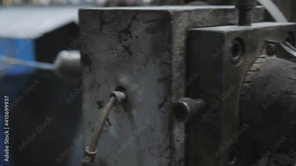 Close-up copper wire in multicolored braid is treated with talcum powder on the plant for the production of electric cable. Close-up copper wire in multicolored braid is treated with talcum powder on the plant for the production of electric cable.