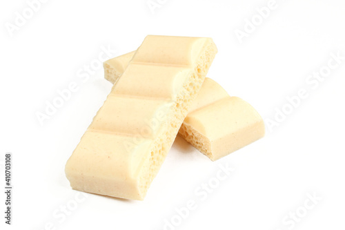 Two pieces of bubbly white milk chocolate isolated on white background