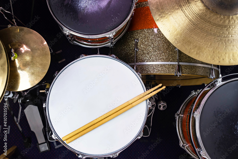 Closeup of drumsticks lying on the professional drum set. Drummer equipment. Closeup of drumsticks lying on the professional drum set. Drummer equipment.
