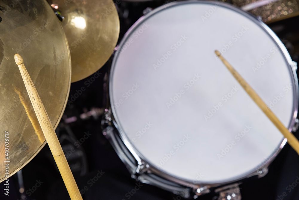 Fototapeta premium Professional drum set closeup. Man drummer with drumsticks playing drums and cymbals, on the live music rock concert or in recording studio &nbsp;