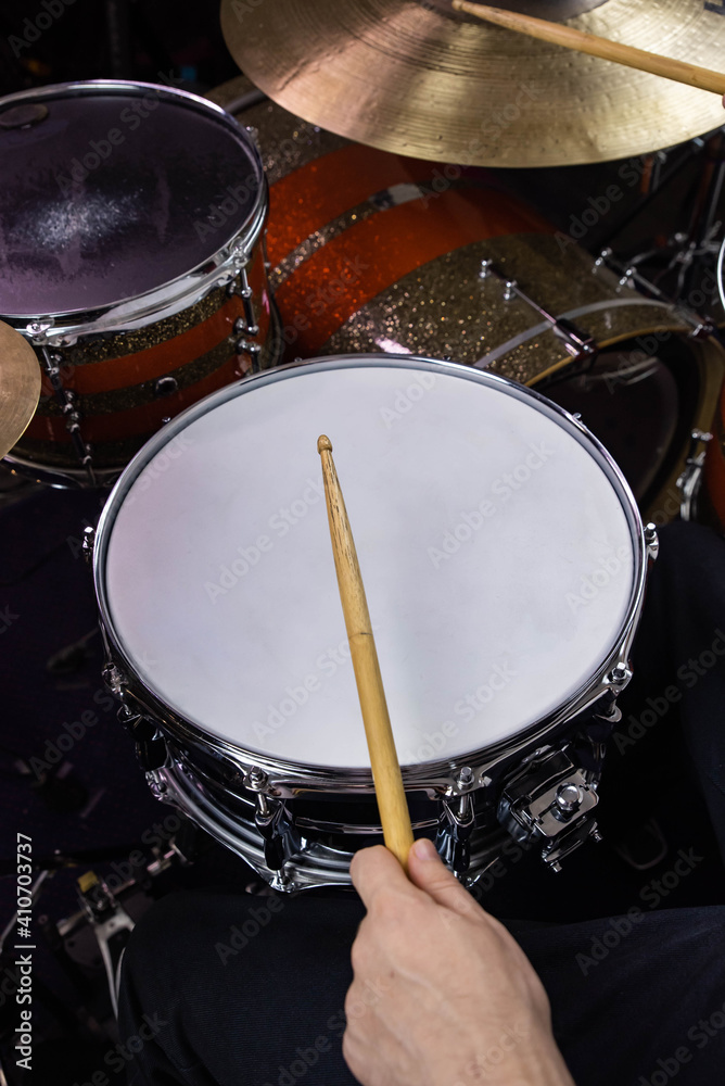 Professional drum set closeup. Man drummer with drumsticks playing drums and cymbals, on the live music rock concert or in recording studio Professional drum set closeup. Man drummer with drumsticks playing drums and cymbals, on the live music rock concert or in recording studio