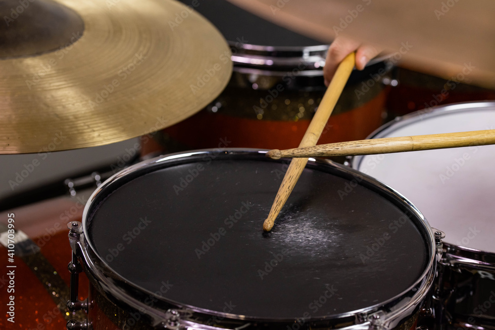 Obraz premium Professional drum set closeup. Man drummer with drumsticks playing drums and cymbals, on the live music rock concert or in recording studio &nbsp;