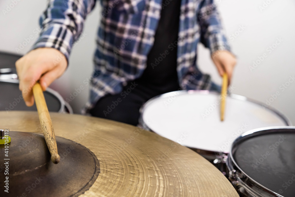 Professional drum set closeup. Man drummer with drumsticks playing drums and cymbals, on the live music rock concert or in recording studio Professional drum set closeup. Man drummer with drumsticks playing drums and cymbals, on the live music rock concert or in recording studio