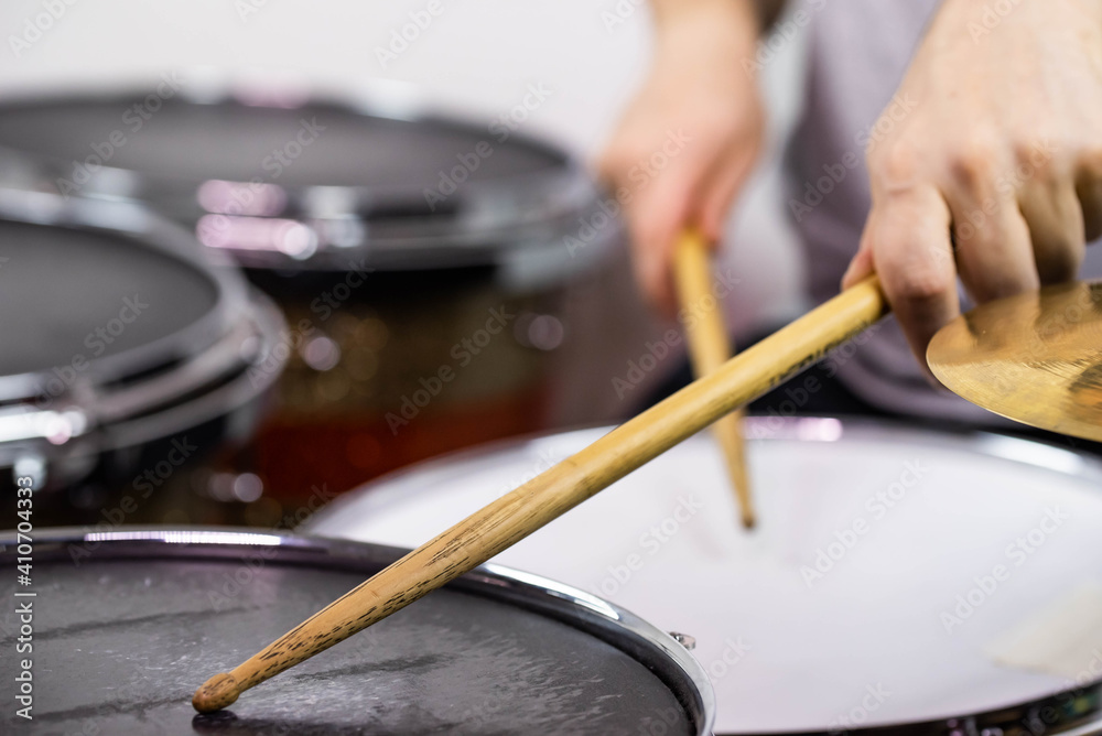 Professional drum set closeup. Man drummer with drumsticks playing drums and cymbals, on the live music rock concert or in recording studio Professional drum set closeup. Man drummer with drumsticks playing drums and cymbals, on the live music rock concert or in recording studio