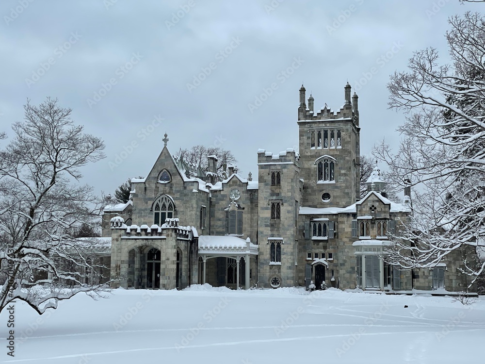 Snow-covered gothic stone mansion
