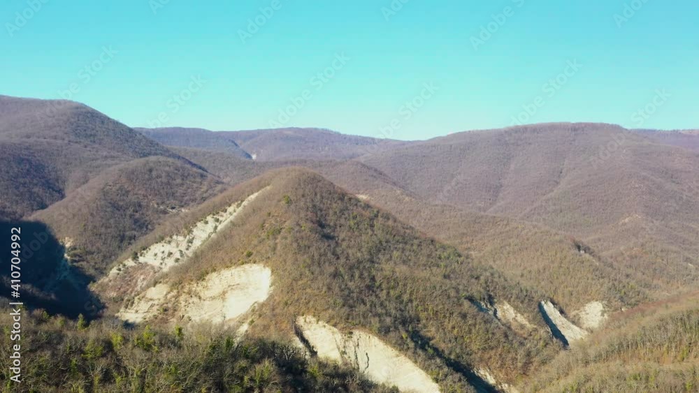 Drone flying above brown mountain forest in sunny day, Gelendzhik city area, Caucasus, Russia Drone flying above brown mountain forest in sunny day, Gelendzhik city area, Caucasus, Russia