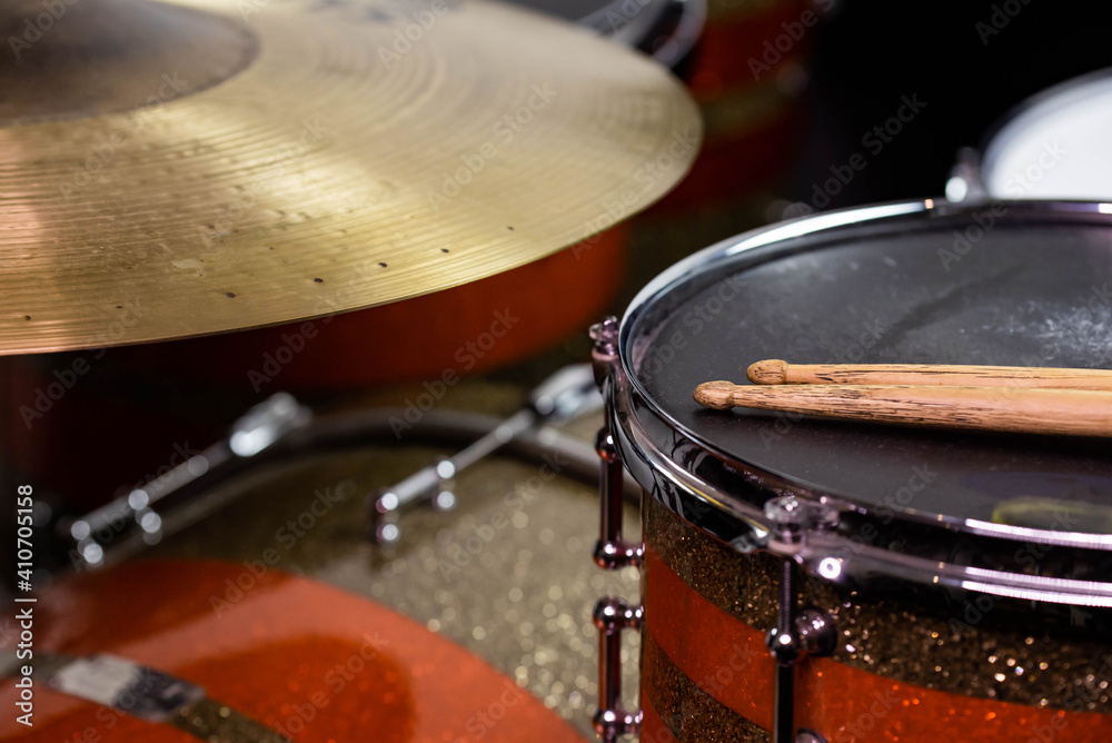 Closeup of drumsticks lying on the professional drum set. Drummer equipment. Closeup of drumsticks lying on the professional drum set. Drummer equipment.