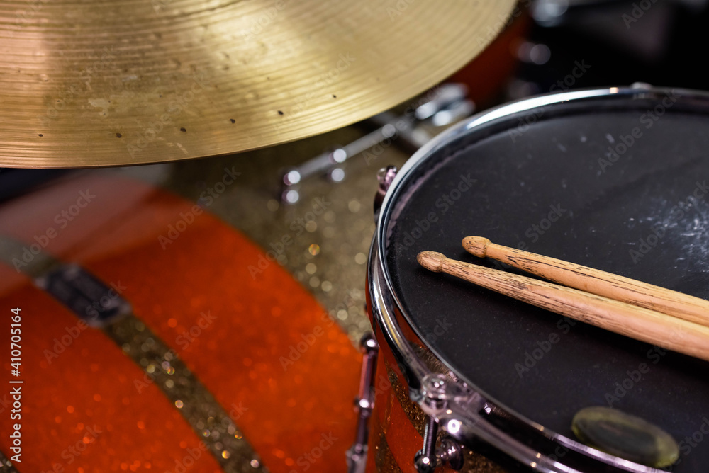 Closeup of drumsticks lying on the professional drum set. Drummer equipment. Closeup of drumsticks lying on the professional drum set. Drummer equipment.
