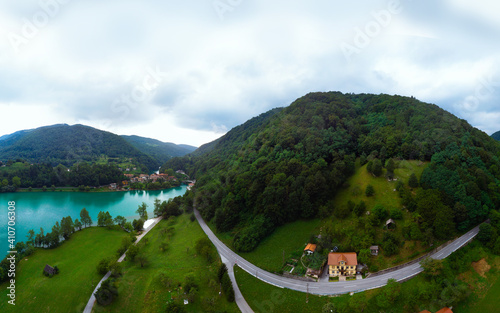 Aerial wide panorama view of Most Na Soci lake road in beautiful colors near Tolmin in Slovenia. Summer cloud day. Mountains. Travel and vacation. Modrej, Modrejce photo