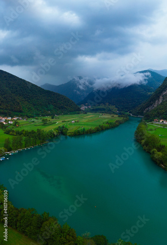aerial view of Most Na Soci lake in beautiful colors near Tolmin in Slovenia. Summer cloud day. Mountains. Travel and vacation. Modrej, Modrejce. vertical photo. photo