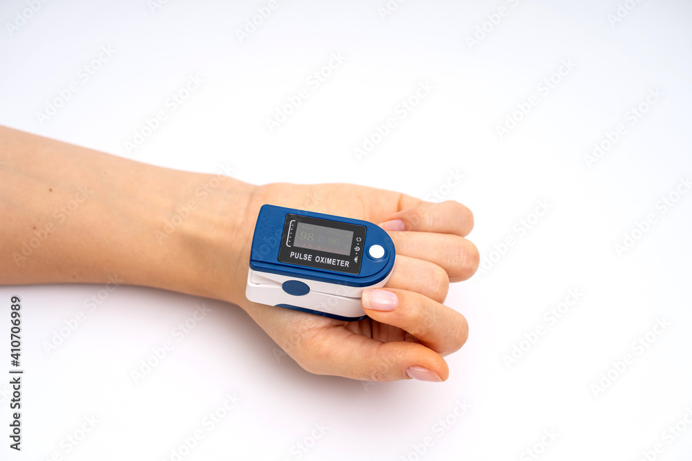 Fingertip Pulse Oximeter on finger. On white background. Device for self health diagnostic Fingertip Pulse Oximeter on finger. On white background. Device for self health diagnostic